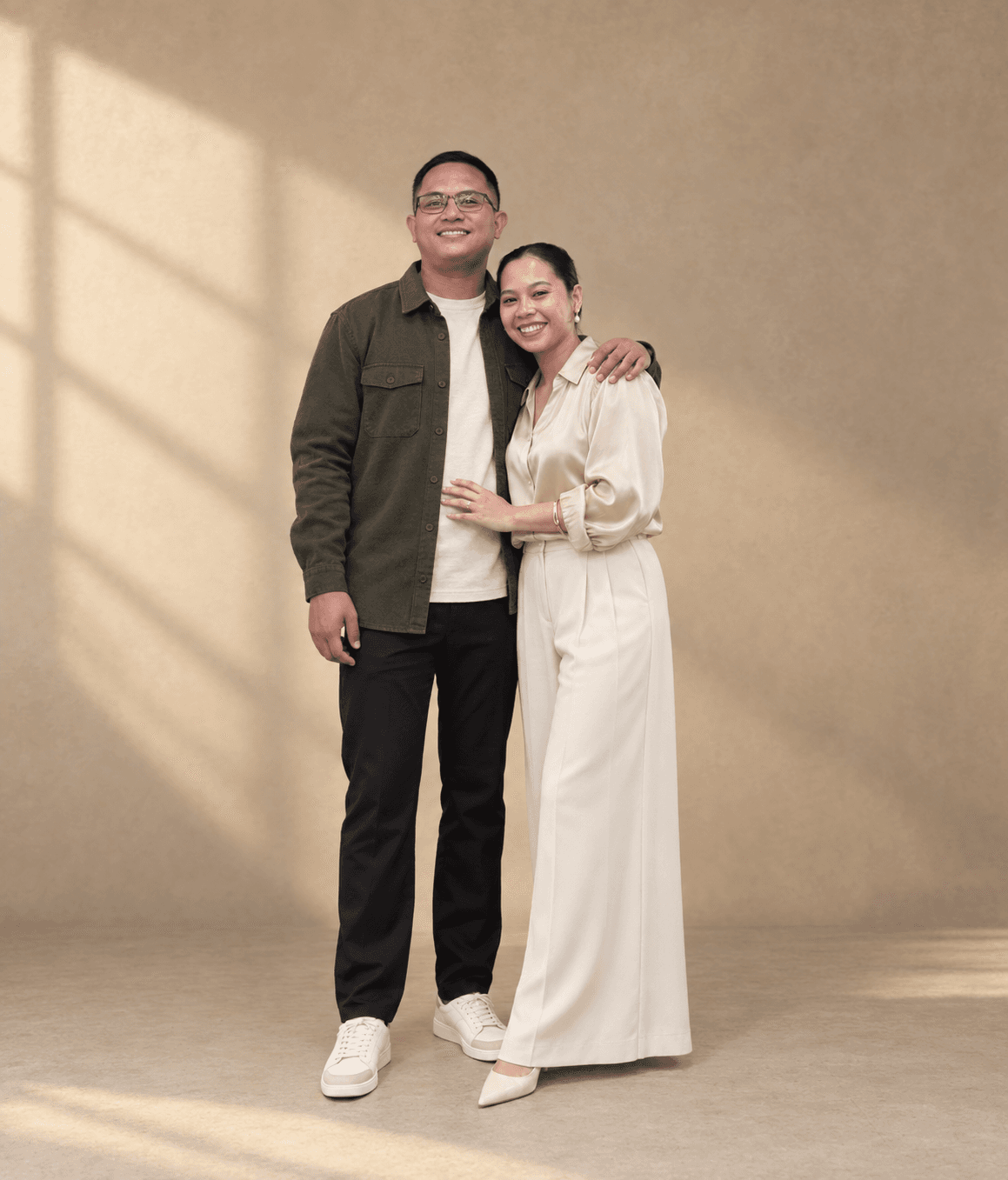 Antonio and Axzel standing together in a warm studio portrait